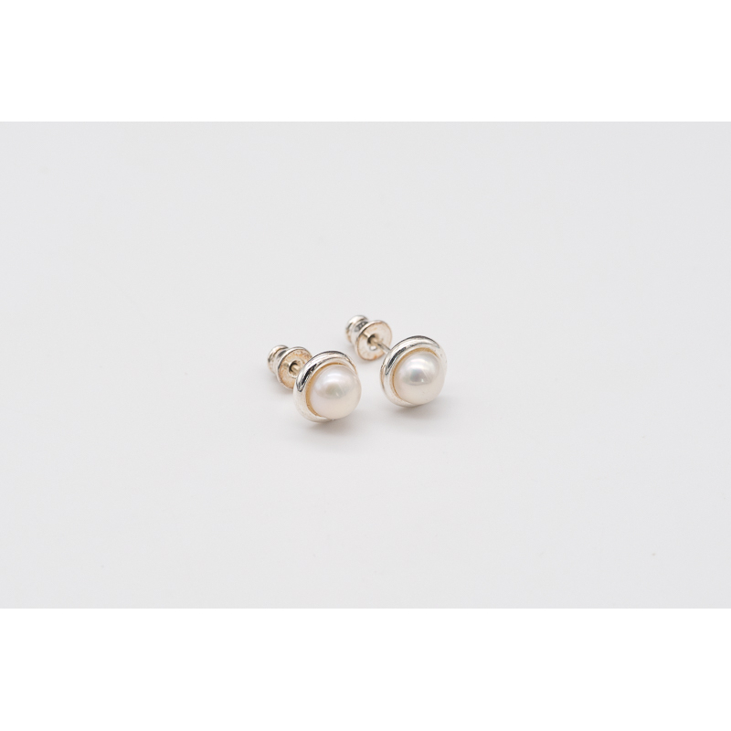 White freshwater pearl studs with silver bezel setting